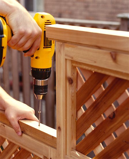 Close Up of Man Drilling Fence Stock Photo - Premium Royalty-Free, Artist: Mark Burstyn, Image code: 600-01015268