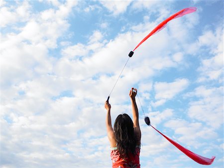 spinning poi - Woman Twirling Poi Stock Photo - Premium Royalty-Free, Code: 600-01029752