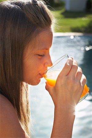 Girl Drinking Orange Juice Stock Photo - Premium Royalty-Free, Code: 600-01036627