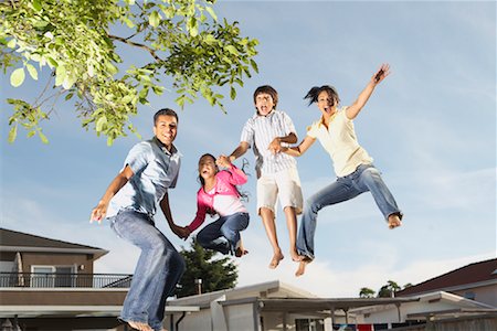 excited happy family and jumping and home - Family Jumping Stock Photo - Premium Royalty-Free, Code: 600-01036890