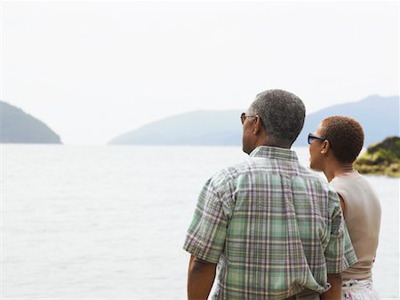 Couple Looking over Water Stock Photo - Premium Royalty-Free, Code: 600-01036956