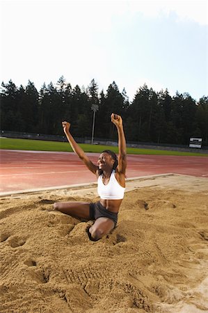 Woman Cheering after Long Jump Foto de stock - Sin royalties Premium, Código: 600-01037038