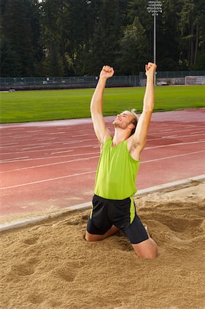 salto em distância - Man Cheering after Long Jump Foto de stock - Royalty Free Premium, Número: 600-01037040
