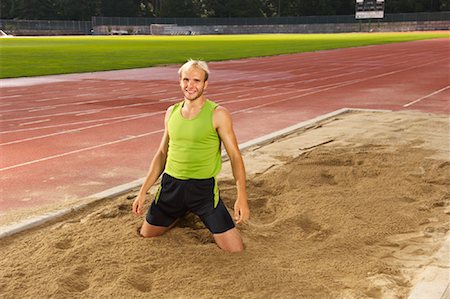 salto in lungo - Man in Long Jump Pit Fotografie stock - Premium Royalty-Free, Codice: 600-01037041