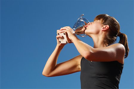 female track and field spandex - Champion Athlete Holding Trophy Stock Photo - Premium Royalty-Free, Code: 600-01037159