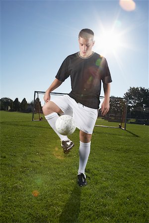 soccer player men game soccer ball kicking - Man Playing Soccer Stock Photo - Premium Royalty-Free, Code: 600-01037264