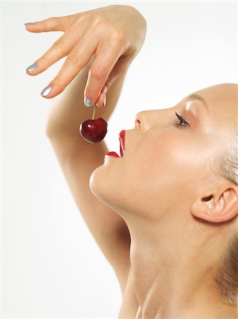 simsearch:600-00846410,k - Woman Eating Cherry Foto de stock - Sin royalties Premium, Código: 600-01037510