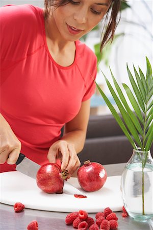 simsearch:600-03814644,k - Woman Cutting Pomegranate Stock Photo - Premium Royalty-Free, Code: 600-01041202
