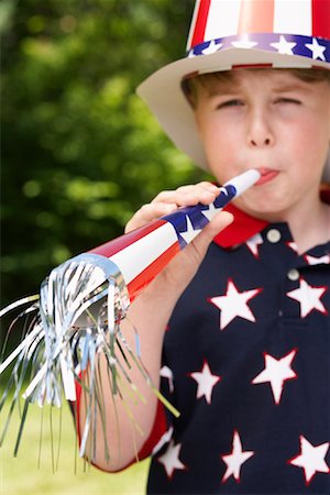 simsearch:700-00984296,k - Portrait of Boy Wearing Stars and Stripes Top and Hat, Blowing Noisemaker Horn Stock Photo - Premium Royalty-Free, Code: 600-01041994