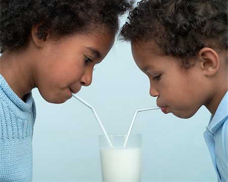 Children Sharing a Glass of Milk Stock Photo - Premium Royalty-Free, Code: 600-01043041