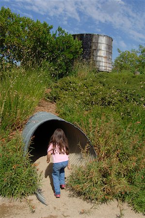 simsearch:700-01072527,k - Girl Exploring Tunnel, The Solar Living Institute, Hopland, California, USA Stock Photo - Premium Royalty-Free, Code: 600-01072459