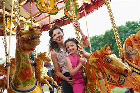 family pic on merry go round - Mother and Daughter on Merry-Go-Round, Carters Steam Fair, England Stock Photo - Premium Royalty-Free, Code: 600-01072612