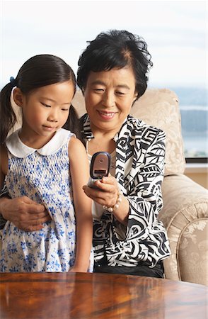 flexible young girls - Grandmother and Granddaughter with Cell Phone Stock Photo - Premium Royalty-Free, Code: 600-01073096