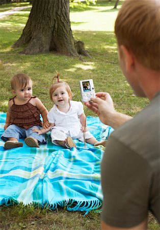 Father Taking Picture of Babies with Digital Camera Stock Photo - Premium Royalty-Free, Code: 600-01073139