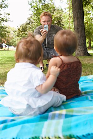 Father Taking Picture of Babies Stock Photo - Premium Royalty-Free, Code: 600-01073145