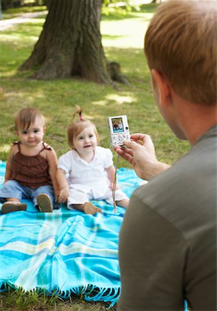 Father Taking Picture of Babies with Digital Camera Stock Photo - Premium Royalty-Free, Code: 600-01073140