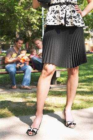 female feet and calves - Woman Standing in Front of Men with Babies in Park Stock Photo - Premium Royalty-Free, Code: 600-01073162