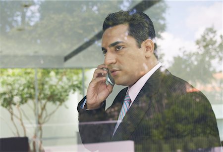 Businessman Using Cellular Phone Stock Photo - Premium Royalty-Free, Code: 600-01073295