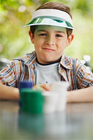 playing poker - Boy with Stacks of Poker Chips Stock Photo - Premium Royalty-Free, Code: 600-01073517