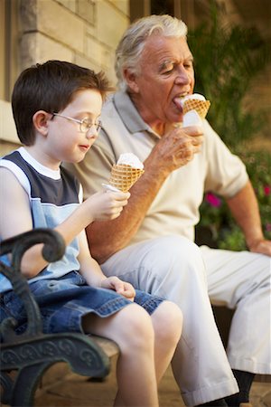 picture of grandpa and grandson eating on a park bench - Grandfather and Grandson Eating Ice Cream Cones Stock Photo - Premium Royalty-Free, Code: 600-01073533