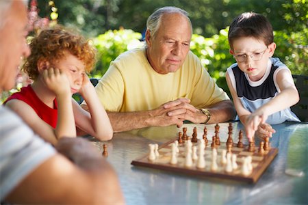 pawn chess piece - Men Playing Chess with their Grandsons Stock Photo - Premium Royalty-Free, Code: 600-01073548