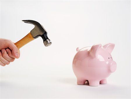 piggy bank hand - Piggy Bank and Hammer Stock Photo - Premium Royalty-Free, Code: 600-01073564