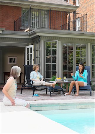 Women Lounging By Pool Stock Photo - Premium Royalty-Free, Code: 600-01084267