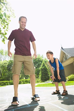 Father and Son Playing Hopscotch Stock Photo - Premium Royalty-Free, Code: 600-01083018