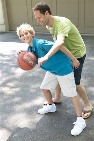 daddy and son playing basketball - Father and Son Playing Basketball Stock Photo - Premium Royalty-Free, Code: 600-01083056