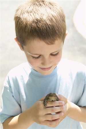 Portrait of Boy Holding Frog Stock Photo - Premium Royalty-Free, Code: 600-01083059