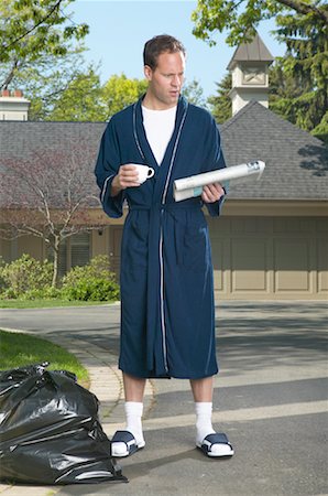 Man Picking Up Newspaper Stock Photo - Premium Royalty-Free, Code: 600-01083064