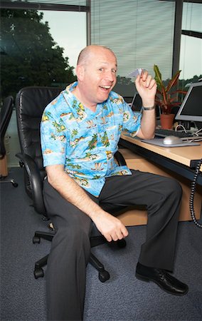person in hawaiian shirt - Businessman at Desk Stock Photo - Premium Royalty-Free, Code: 600-01083347