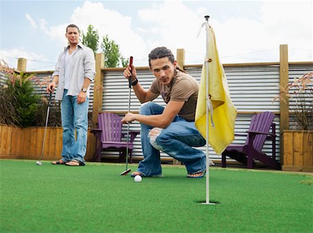 Friends Playing Miniature Golf Stock Photo - Premium Royalty-Free, Code: 600-01083744