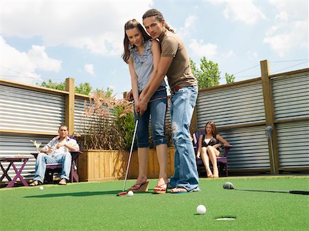 female golfers putting stances - Couple Playing Miniature Golf Stock Photo - Premium Royalty-Free, Code: 600-01083755