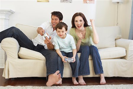 Father, Mother and Son Playing Video Game Stock Photo - Premium Royalty-Free, Code: 600-01083823