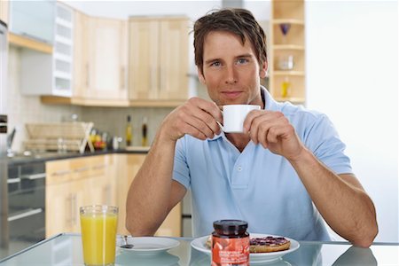 drinks on table coffee juice - Man Eating Breakfast Stock Photo - Premium Royalty-Free, Code: 600-01083834