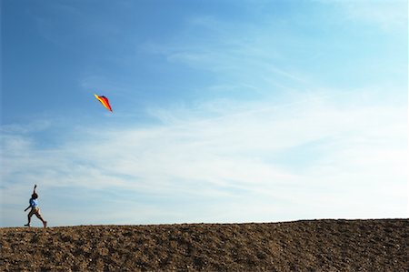 space with a person floating - Boy Flying Kite Stock Photo - Premium Royalty-Free, Code: 600-01109691