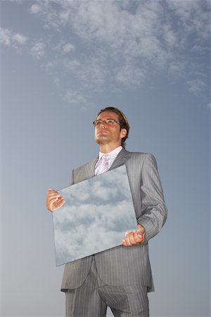 simsearch:600-01275479,k - Businessman Reflecting Sky in Mirror Stock Photo - Premium Royalty-Free, Code: 600-01109933