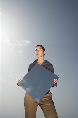 Woman Reflecting Sky in Mirror Stock Photo - Premium Royalty-Free, Code: 600-01109941