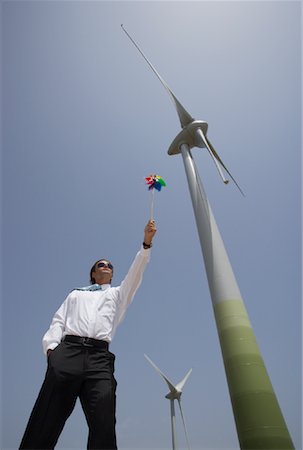 Businessman with Pinwheel by Wind Turbine Stock Photo - Premium Royalty-Free, Code: 600-01109969