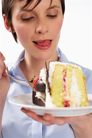 person licking lips - Woman Eating Cake Stock Photo - Premium Royalty-Free, Code: 600-01110043