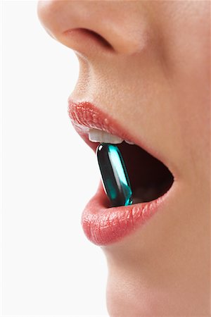 simsearch:600-01110057,k - Woman's Mouth with Gel Cap Stock Photo - Premium Royalty-Free, Code: 600-01110063