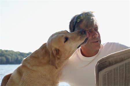 dog licking face - Man Outdoors with Dog, Three Mile Lake, Muskoka, Ontario, Canada Stock Photo - Premium Royalty-Free, Code: 600-01111418