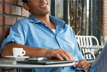 drinking coffee on patio - Man Sitting at Cafe Table Stock Photo - Premium Royalty-Free, Code: 600-01111960