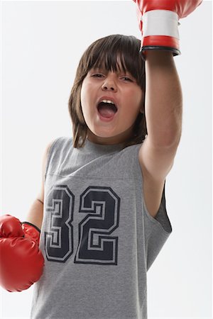 picture of boxer with mouth open - Portrait of Boy Wearing Boxing Gloves Stock Photo - Premium Royalty-Free, Code: 600-01112024