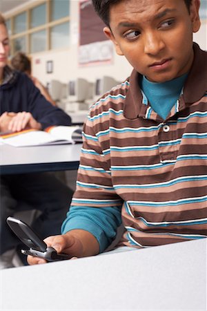 Student Using Cell Phone in Classroom Stock Photo - Premium Royalty-Free, Code: 600-01112265
