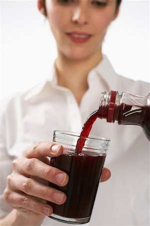 simsearch:600-01110057,k - Woman Pouring Pomegranate Juice Stock Photo - Premium Royalty-Free, Code: 600-01112465