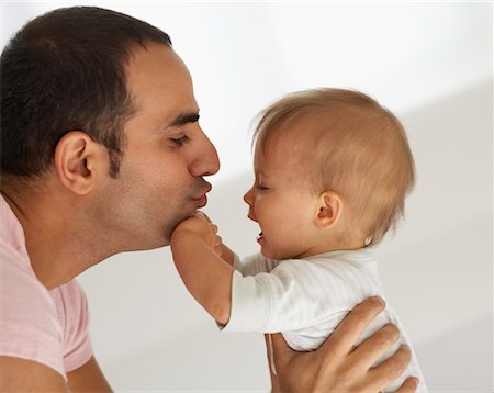 sad face side profile - Father Comforting Baby Stock Photo - Premium Royalty-Free, Code: 600-01112874