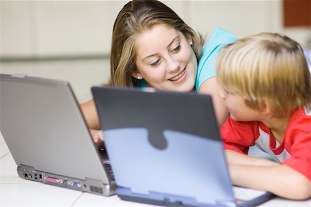 Girl and Boy Using Laptop Computers Fotografie stock - Premium Royalty-Free, Codice: 600-01112914