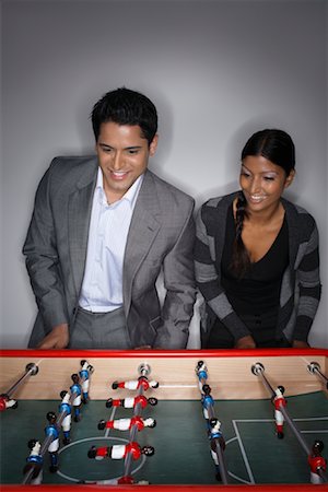 playing table soccer - Man and Woman Playing Table Soccer Stock Photo - Premium Royalty-Free, Code: 600-01124180
